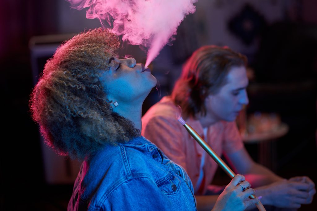 Woman Exhaling Hookah Smoke